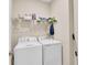 Laundry room with modern, white, front-loading washer and dryer at 9856 Sw 100Th Ter, Ocala, FL 34481