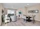 Open-concept living room with modern furnishings, fireplace, ceiling fan, and beautiful gray wood-look floors at 9856 Sw 100Th Ter, Ocala, FL 34481