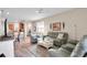 Bright living room with modern gray furniture and decor and view to the kitchen at 9856 Sw 100Th Ter, Ocala, FL 34481