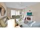 Inviting living room featuring a fireplace, comfortable seating, and stylish decor with wood-look laminate flooring at 9856 Sw 100Th Ter, Ocala, FL 34481