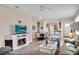 Cozy living room with fireplace, TV, dining area and view of the kitchen at 9856 Sw 100Th Ter, Ocala, FL 34481