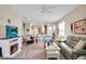 Open-concept living room with fireplace, dining area, and modern furnishings at 9856 Sw 100Th Ter, Ocala, FL 34481