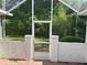 Backyard access through the enclosed patio features a secure, gated entry to the backyard at 11014 Sw 73Rd Cir, Ocala, FL 34476