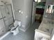 Bright bathroom featuring a walk-in shower, dual sinks, and toilet with accessibility features at 11014 Sw 73Rd Cir, Ocala, FL 34476