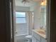 Bathroom featuring a shower-tub combo, a granite vanity with sink and a window for ample light at 11014 Sw 73Rd Cir, Ocala, FL 34476