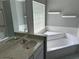Well lit bathroom featuring a glass block window, tub and shower combo, and a vanity with a sink at 11014 Sw 73Rd Cir, Ocala, FL 34476