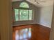 Bedroom with vaulted ceilings, laminate floors and large windows for ample natural light at 11014 Sw 73Rd Cir, Ocala, FL 34476