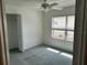 This bedroom features neutral carpet, a ceiling fan and a window for natural light and an adequate closet space at 11014 Sw 73Rd Cir, Ocala, FL 34476