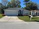 Charming single-story home boasts a well-manicured lawn and attached two-car garage at 11014 Sw 73Rd Cir, Ocala, FL 34476