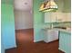 Open kitchen showcasing bright green walls, hardwood floors, and white appliances at 11014 Sw 73Rd Cir, Ocala, FL 34476