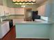 Open kitchen featuring sleek countertops, stylish lighting, and modern appliances at 11014 Sw 73Rd Cir, Ocala, FL 34476