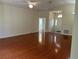 The open living room boasts gleaming hardwood floors, vaulted ceiling, and an arched transom window over the entry door at 11014 Sw 73Rd Cir, Ocala, FL 34476