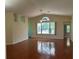 Open living room features vaulted ceilings, a ceiling fan, and large windows for abundant natural light at 11014 Sw 73Rd Cir, Ocala, FL 34476