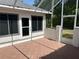 Enclosed patio features tile flooring and a door to the backyard, perfect for outdoor living at 11014 Sw 73Rd Cir, Ocala, FL 34476