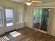 Charming sunroom with wood-look floors, ceiling fan, and access to both the kitchen and backyard at 11014 Sw 73Rd Cir, Ocala, FL 34476