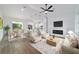 Staged open-concept living room features fireplace, kitchen island, and dining area at 119 Water Trak, Ocala, FL 34472