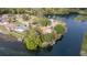 Aerial view of riverside home with boat dock and lush surrounding trees on waterfront property at 12180 Maple St, Dunnellon, FL 34432