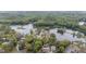 Expansive aerial view of riverside homes surrounded by lush trees and serene waters at 12180 Maple St, Dunnellon, FL 34432