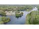 Scenic aerial view of riverside community surrounded by lush trees and serene waters at 12180 Maple St, Dunnellon, FL 34432