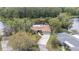 Aerial view of the home highlighting its mature landscaping, private setting, and convenient attached garage at 12180 Maple St, Dunnellon, FL 34432