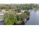 Picturesque aerial view of waterfront home with mature trees and a tranquil dock at 12180 Maple St, Dunnellon, FL 34432