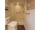 Bathroom featuring walk-in shower with grab bars, comfort height toilet, and tile flooring at 12180 Maple St, Dunnellon, FL 34432