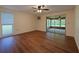 Spacious bedroom with wood-look floors, ceiling fan, a large window, and access to a sunroom at 12180 Maple St, Dunnellon, FL 34432