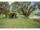 Riverside property with dock and lush, mature trees, providing a serene setting at 12180 Maple St, Dunnellon, FL 34432