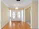 Entry foyer features a large decorative front door, hardwood floors, and ample space for greeting guests at 12180 Maple St, Dunnellon, FL 34432