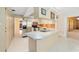 Open kitchen design with breakfast bar and laminate countertops offering a seamless dining experience at 12180 Maple St, Dunnellon, FL 34432
