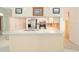 Bright kitchen with breakfast bar, white cabinets, and modern stainless steel appliances at 12180 Maple St, Dunnellon, FL 34432