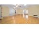 Spacious living area with hardwood floors, ceiling fans, and an adjacent tiled area, perfect for entertaining at 12180 Maple St, Dunnellon, FL 34432