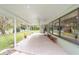 Covered outdoor patio with views of a lake, offering a serene space for relaxation and entertainment at 12180 Maple St, Dunnellon, FL 34432