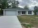 Charming single-Gathering home with attached garage and freshly poured concrete driveway at 13375 Se 42Nd Ave, Belleview, FL 34420