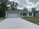 Newly built single-Gathering home featuring a two-car garage and a concrete driveway at 13375 Se 42Nd Ave, Belleview, FL 34420