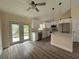 Bright kitchen with white cabinets, stainless steel appliances, and wood-look flooring at 13375 Se 42Nd Ave, Belleview, FL 34420