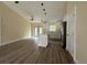 Open-concept living room with wood-look flooring, ceiling fan, and island with pendant lighting at 13375 Se 42Nd Ave, Belleview, FL 34420