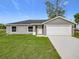 Charming single-story home with a well-manicured lawn and attached two-car garage, offering comfort and convenience at 14914 Se 28Th Ct, Summerfield, FL 34491