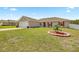 Well-kept exterior with a neat lawn and manicured garden bed in a serene neighborhood at 15470 Sw 34Th Ave, Ocala, FL 34473