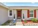 Close-up of the front entrance featuring a classic wood door and manicured landscaping at 15470 Sw 34Th Ave, Ocala, FL 34473