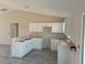 Bright kitchen features ample white cabinets and modern flooring, awaiting personalization at 2 Malauka Loop Ln, Ocklawaha, FL 32179