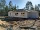 A charming single-story home featuring a side-entry garage and freshly prepared surrounding land at 31 Fisher Run, Ocklawaha, FL 32179