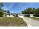 Charming single-story home featuring a well-manicured lawn and a long private driveway at 13269 Sw 112Th St, Dunnellon, FL 34432