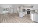 Open-concept living space with stainless steel kitchen appliances and light gray laminate flooring at 13269 Sw 112Th St, Dunnellon, FL 34432
