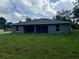 The backyard of the home features a freshly cut lawn and a back exterior view at 15099 Sw 29Th Terrace Rd, Ocala, FL 34473