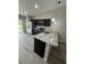Well-equipped kitchen features stainless steel appliances, dark cabinets and sleek granite countertops at 15099 Sw 29Th Terrace Rd, Ocala, FL 34473