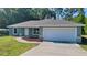 Charming single-story home featuring a neutral color scheme, an attached two-car garage, and a well-maintained lawn at 19920 Sw Eagle Dr, Dunnellon, FL 34431