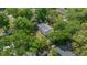 An aerial view shows the home's backyard, elevated deck, and surrounding mature trees, offering a private retreat at 341 Se 53Rd Ct, Ocala, FL 34480