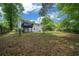 Spacious backyard features a raised deck, mature trees, and ample room for outdoor activities and entertaining at 341 Se 53Rd Ct, Ocala, FL 34480