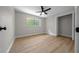 A cozy bedroom featuring a ceiling fan, wood floors and a closet at 341 Se 53Rd Ct, Ocala, FL 34480